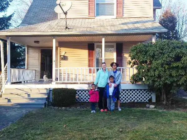 A family standing in front of their new home through the PMHA homeownership program